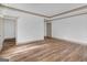 Spacious bedroom featuring hardwood floors and multiple doorways at 6274 Booker Ln, Lithonia, GA 30058
