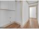 Hallway features wood floors, white walls, and white cabinets for storage at 6274 Booker Ln, Lithonia, GA 30058