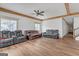 Large living room with hardwood floors, ceiling fans, and natural light at 6274 Booker Ln, Lithonia, GA 30058