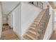 Elegant staircase with wood steps, metal railings, and natural light at 6274 Booker Ln, Lithonia, GA 30058