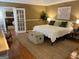 Bright bedroom with hardwood floors, a cozy rug, and access to the living room at 200 Timber Ridge Dr, Mcdonough, GA 30252