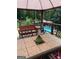 Deck with outdoor seating and views of the pool and lush foliage at 200 Timber Ridge Dr, Mcdonough, GA 30252