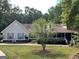 Charming single-Gathering home with a well-manicured lawn, inviting front porch, and lush landscaping at 200 Timber Ridge Dr, Mcdonough, GA 30252