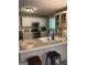 Bright kitchen featuring white cabinets, stainless steel appliances, and a breakfast bar at 200 Timber Ridge Dr, Mcdonough, GA 30252