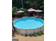 Inviting above-ground pool and spacious deck with an outdoor dining and lounge area at 200 Timber Ridge Dr, Mcdonough, GA 30252