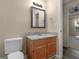 Bathroom vanity with a wood cabinet, granite countertop, and decorative lighting at 124 Williams Blf, Mcdonough, GA 30252