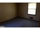 Modest bedroom with a window offering natural light and carpeted flooring at 376 Lakewood Dr, Social Circle, GA 30025
