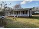 Charming single-story home with a cozy front porch and well-maintained lawn at 376 Lakewood Dr, Social Circle, GA 30025