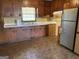 Kitchen featuring wooden cabinets, laminated counter, and stainless steel refrigerator at 376 Lakewood Dr, Social Circle, GA 30025