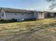Exterior view of home with a backyard featuring a spacious lawn at 376 Lakewood Dr, Social Circle, GA 30025