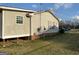 Side view of home with siding and brick foundation at 376 Lakewood Dr, Social Circle, GA 30025