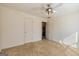 Secondary bedroom featuring neutral carpet, a ceiling fan, and an adjoining bathroom at 195 Youngs Cir, Fayetteville, GA 30215