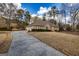 Brick home with a large driveway and attached two-car garage at 195 Youngs Cir, Fayetteville, GA 30215