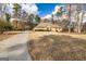 Wide view of a brick home with a large front yard and paved driveway at 195 Youngs Cir, Fayetteville, GA 30215
