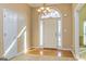 Welcoming foyer with hardwood floors, decorative chandelier, and a bright front door at 195 Youngs Cir, Fayetteville, GA 30215