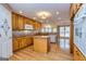 Well-lit kitchen with wooden cabinets, center island, and hardwood floors at 195 Youngs Cir, Fayetteville, GA 30215