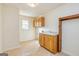 Functional laundry room with storage cabinets, a utility sink, and neutral tile flooring at 195 Youngs Cir, Fayetteville, GA 30215