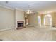 Cozy living room featuring a brick fireplace, neutral carpet, and chandelier at 195 Youngs Cir, Fayetteville, GA 30215