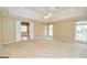 Spacious main bedroom with a ceiling fan, neutral carpeting, and a glimpse into the en-suite bathroom at 195 Youngs Cir, Fayetteville, GA 30215