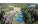 Panoramic aerial shot showcasing tennis courts, a pool, a lake and parking within a wooded community at 130 Dockside Dr # 380, Fayetteville, GA 30215