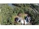 Aerial view of two homes on a wooded lot with a serene river nearby in Fayetteville, GA at 130 Dockside Dr # 380, Fayetteville, GA 30215