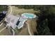 Aerial view of the clubhouse with a pool, lake, and tennis courts at the Canoe Club in Fayetteville, GA at 130 Dockside Dr # 380, Fayetteville, GA 30215