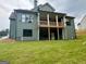 The backyard features a covered patio and green lawn with the rear view of the house at 130 Dockside Dr # 380, Fayetteville, GA 30215