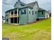 The backyard features a covered patio and green lawn with the rear view of the house at 130 Dockside Dr # 380, Fayetteville, GA 30215