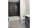 Dark tiled bathroom with tub and toilet at 130 Dockside Dr # 380, Fayetteville, GA 30215