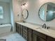 Bright bathroom featuring double vanities, with modern faucets and oval mirrors at 130 Dockside Dr # 380, Fayetteville, GA 30215
