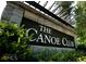 Close up of The Canoe Club community sign with stone pillars and lush greenery at 130 Dockside Dr # 380, Fayetteville, GA 30215