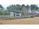 Stone entrance to The Canoe Club with mature landscaping at 130 Dockside Dr # 380, Fayetteville, GA 30215
