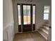 Inviting entryway with a wood front door, hardwood floors, and staircase to the second floor at 130 Dockside Dr # 380, Fayetteville, GA 30215
