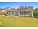 Beautifully landscaped home with green siding, a gabled roof, and well-maintained lawn at 130 Dockside Dr # 380, Fayetteville, GA 30215