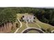 Aerial view of a traditional home with manicured lawn and mature trees on a spacious lot at 130 Dockside Dr # 380, Fayetteville, GA 30215