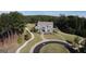 Aerial view of a beautiful gray home with inviting curb appeal, manicured lawn, and mature trees at 130 Dockside Dr # 380, Fayetteville, GA 30215