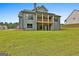 Rear exterior showing a deck, covered patio, and a large grassy yard at 130 Dockside Dr # 380, Fayetteville, GA 30215