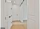 Bright hallway with wooden floors, white walls, and white doors with black hardware at 130 Dockside Dr # 380, Fayetteville, GA 30215
