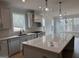 Bright, open kitchen showcases a large island with stone countertops and modern appliances at 130 Dockside Dr # 380, Fayetteville, GA 30215