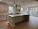 Open kitchen features a large island and modern appliances with ample natural light at 130 Dockside Dr # 380, Fayetteville, GA 30215