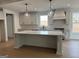 Gorgeous kitchen with a large island, pendant lighting, stainless appliances and light gray cabinets at 130 Dockside Dr # 380, Fayetteville, GA 30215