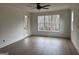 Spacious living room featuring hardwood floors, large windows, and natural light at 130 Dockside Dr # 380, Fayetteville, GA 30215