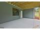 Covered patio features a concrete floor, gray wood paneled walls, a window, and a white door at 130 Dockside Dr # 380, Fayetteville, GA 30215
