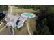 Aerial view of a beautiful pool area with tables, umbrellas, lake and lush greenery in this community at 130 Dockside Dr # 380, Fayetteville, GA 30215