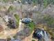 Aerial view of a two-story home with a private driveway, set among mature trees in a quiet neighborhood at 25 Grange Way, Sharpsburg, GA 30277