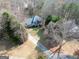 Aerial view of a charming two-story home with a well-manicured lawn and mature trees at 25 Grange Way, Sharpsburg, GA 30277