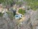 Aerial view of the home's backyard featuring a deck overlooking a quiet wooded neighborhood at 25 Grange Way, Sharpsburg, GA 30277