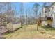 Fenced backyard featuring a deck, storage shed, and lush green lawn at 25 Grange Way, Sharpsburg, GA 30277