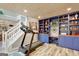 Finished basement with exercise equipment, custom shelving, and a cozy atmosphere at 25 Grange Way, Sharpsburg, GA 30277