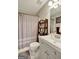 Well-lit bathroom featuring a modern vanity, a shower with curtain, and updated fixtures at 25 Grange Way, Sharpsburg, GA 30277